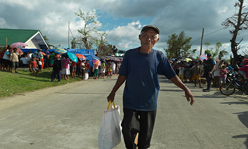Man walking after typhoon in Philippines