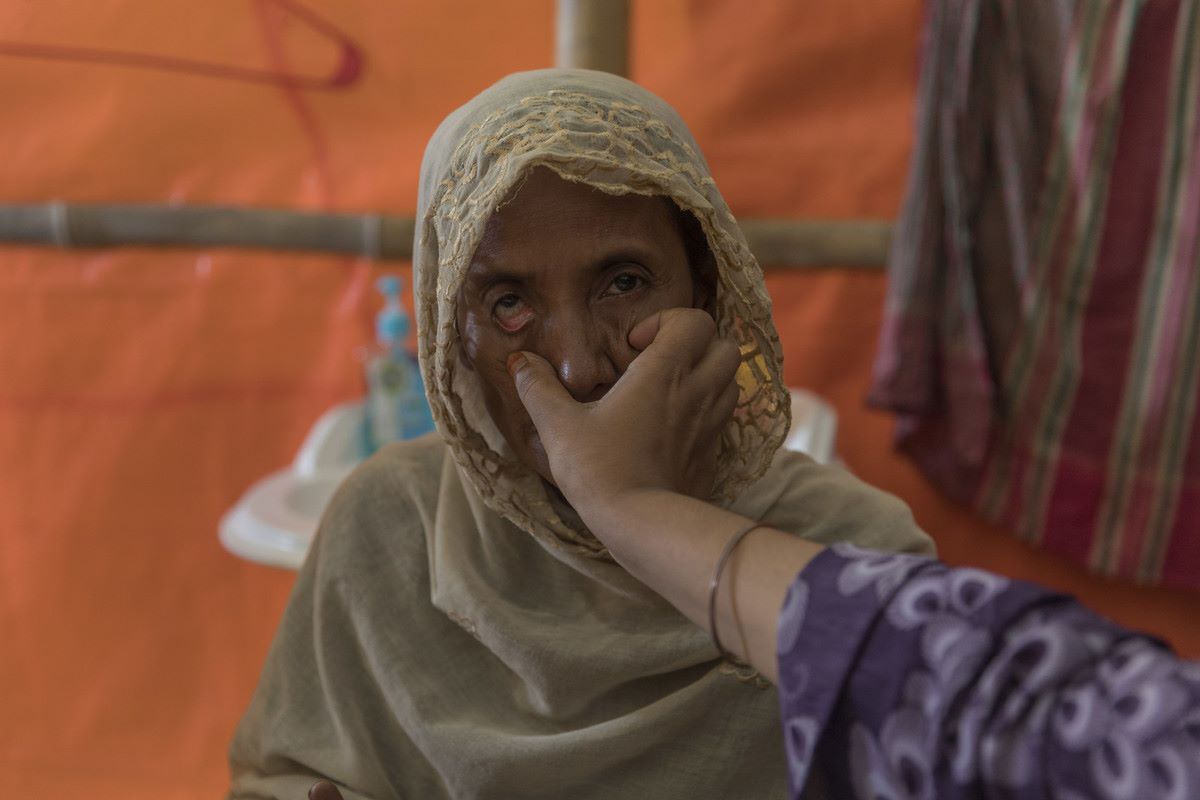 An older Rohingya refugee has her eye's examined in Age International's Age Friendly Space