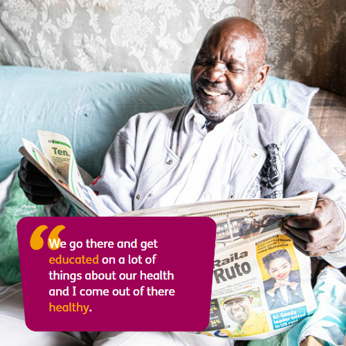 Older man seated smiling as he reads a newspaper. Text: "We go there and get  educated on a lot of things about our health and I come out of there healthy."